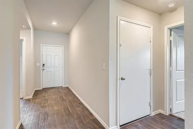 a view of hallway with wooden floor