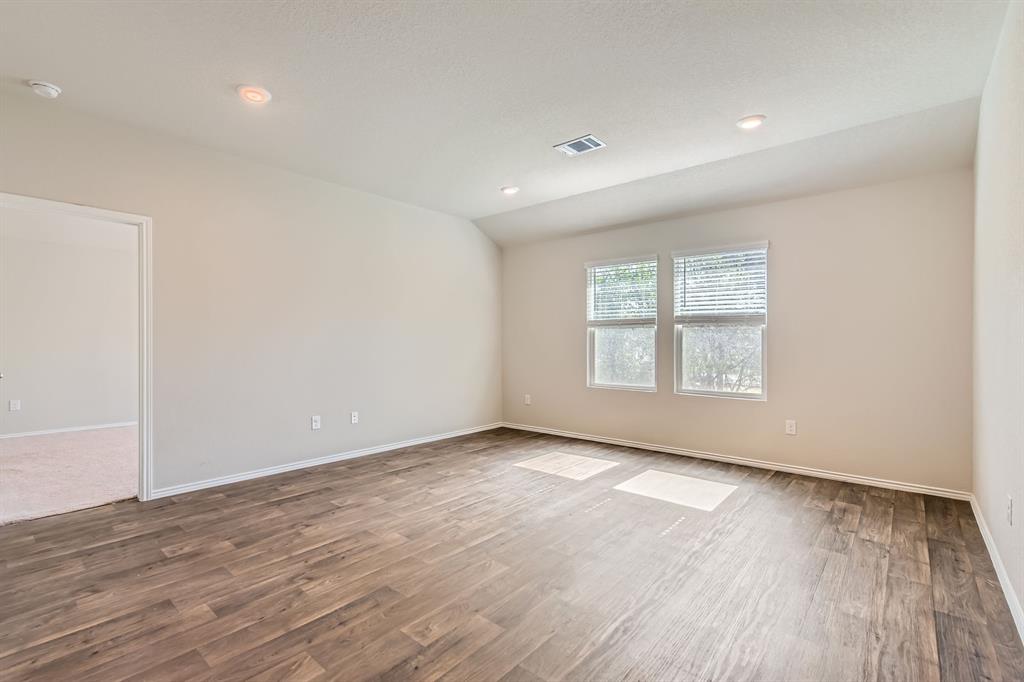 6417 Wideleaf Drive Austin, TX 78724 - Photo 7 of 27 an empty room with wooden floor and windows