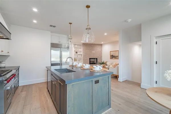 a view of kitchen island a sink and living room view