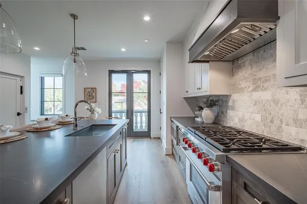 a kitchen with granite countertop a stove and a sink