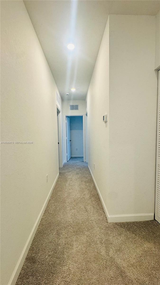 19479 Southwest 340th Street, Unit 1 Homestead, FL 33034 - Photo 7 of 58 an empty room with a natural light