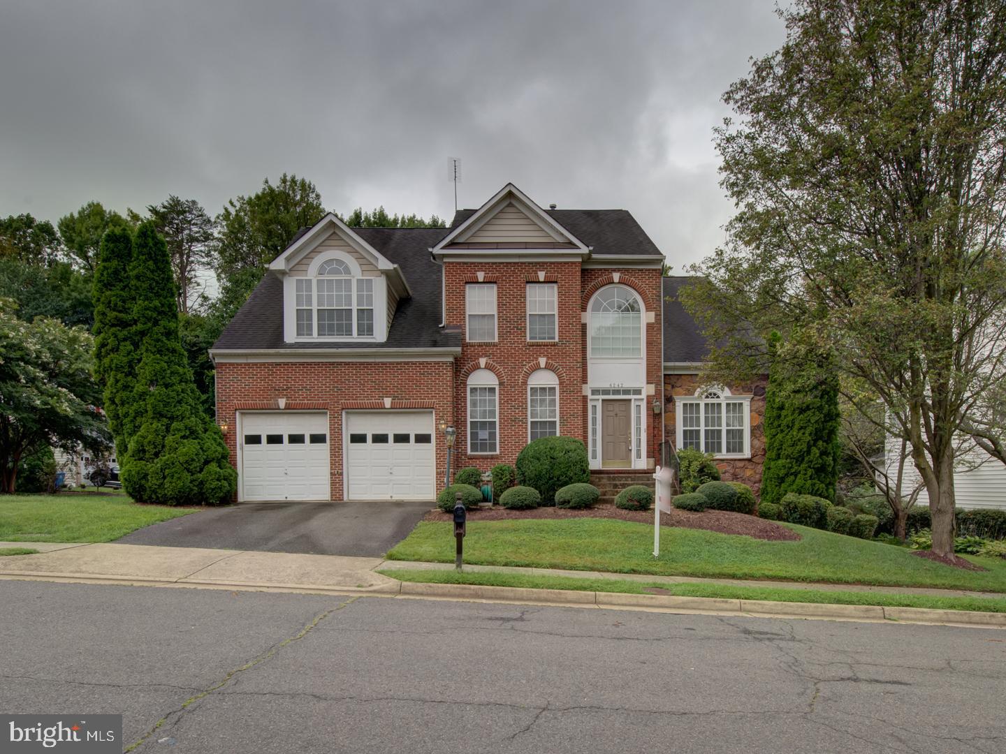 6242 Rolling Spring Court Springfield, VA 22152 - Photo 1 of 1 a front view of a house with a yard and trees