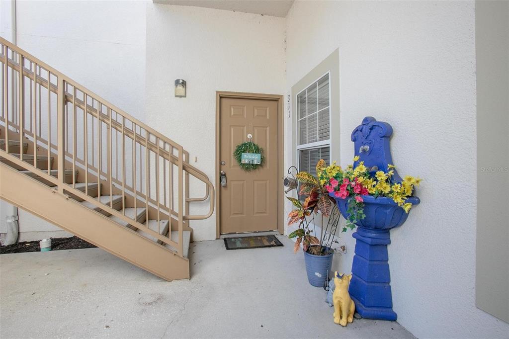 970 North Spring Garden Avenue, Unit 311 DeLand, FL 32720 - Photo 3 of 16 a hallway with beautiful flowers and wooden floor