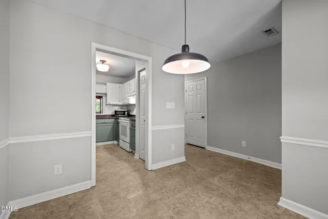 a view of a kitchen with a sink and dishwasher a refrigerator with wooden floor