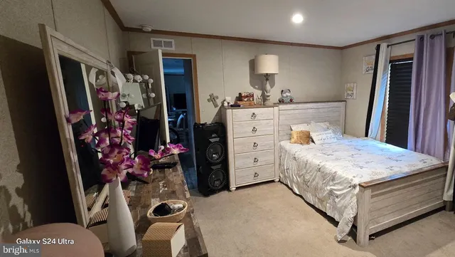 a bedroom with a bed and a dresser