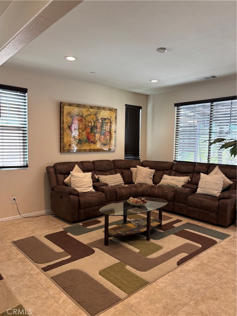 2534 Mapleleaf Terrace Palmdale, CA 93551 - Photo 12 of 48 a living room with furniture and a rug