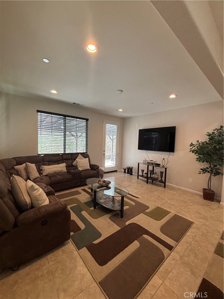 2534 Mapleleaf Terrace Palmdale, CA 93551 - Photo 13 of 48 a living room with furniture and a flat screen tv