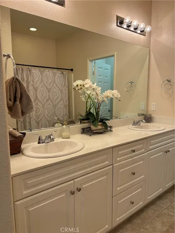 a bathroom with a sink vanity granite and a mirror