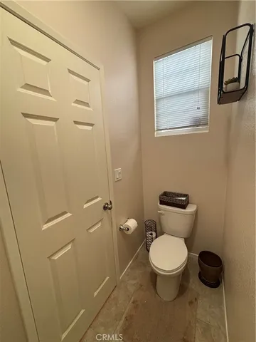 a white toilet sitting next to a bathroom sink