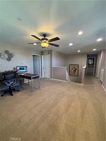 a view of a livingroom with furniture and a ceiling fan