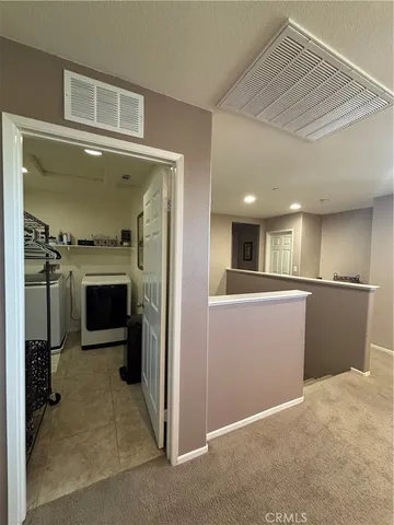 a view of a hallway with a kitchen