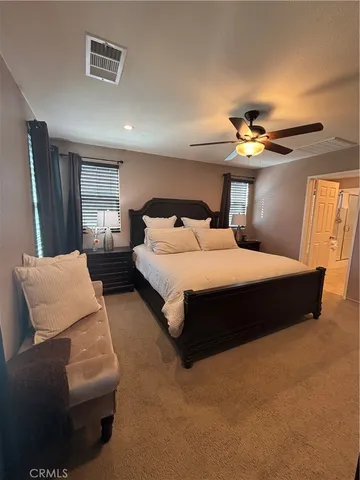 a bedroom with a bed couch and window