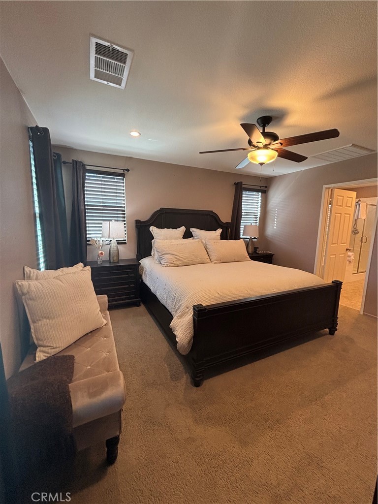 2534 Mapleleaf Terrace Palmdale, CA 93551 - Photo 25 of 48 a bedroom with a bed couch and window