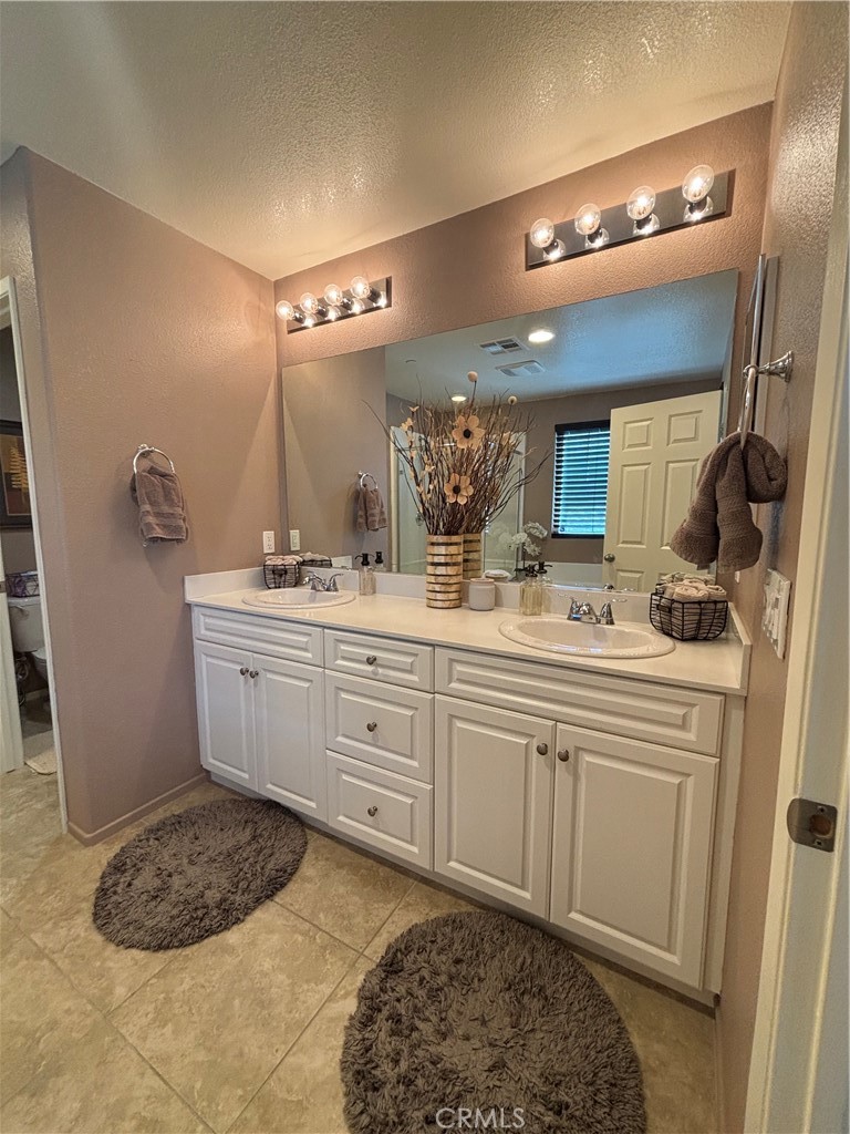 2534 Mapleleaf Terrace Palmdale, CA 93551 - Photo 26 of 48 a bathroom with a sink vanity granite and a mirror