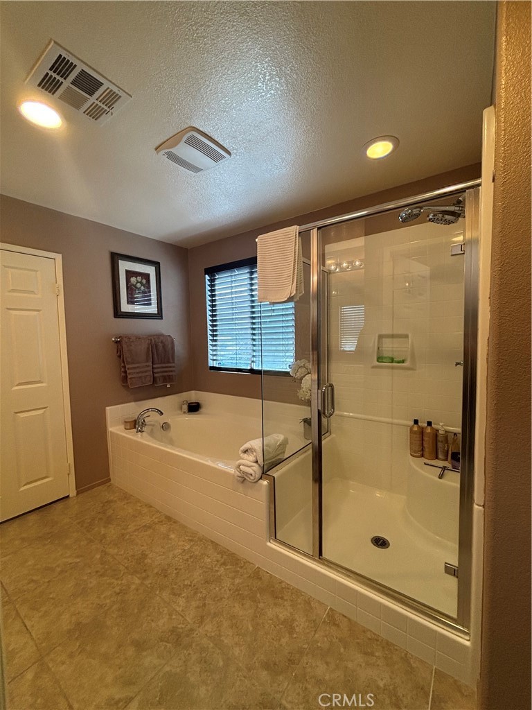 2534 Mapleleaf Terrace Palmdale, CA 93551 - Photo 28 of 48 a bathroom with a tub and shower