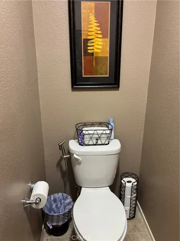 a white toilet sitting next to a bathroom sink and vanity