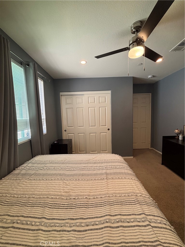 2534 Mapleleaf Terrace Palmdale, CA 93551 - Photo 37 of 48 a large bedroom with a large bed and a chandelier