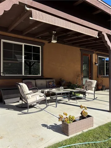 a view of a patio with table and chairs and potted plants