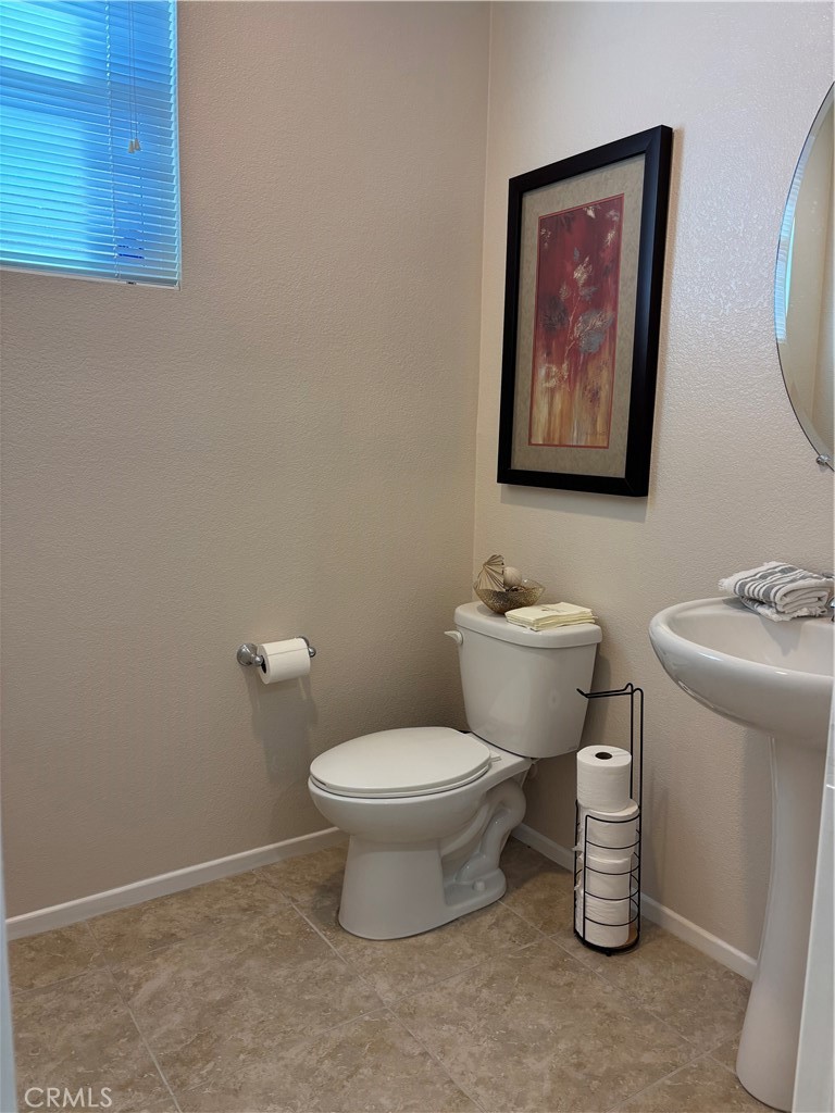 2534 Mapleleaf Terrace Palmdale, CA 93551 - Photo 6 of 48 a bathroom with a toilet a sink and a shower