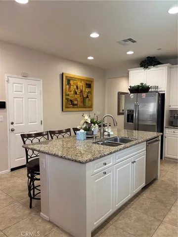 a kitchen with stainless steel appliances granite countertop a sink and cabinets