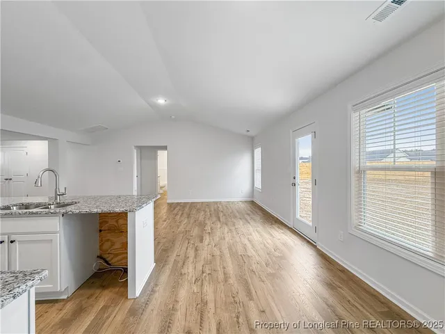 a view of a kitchen counter space and wooden floor