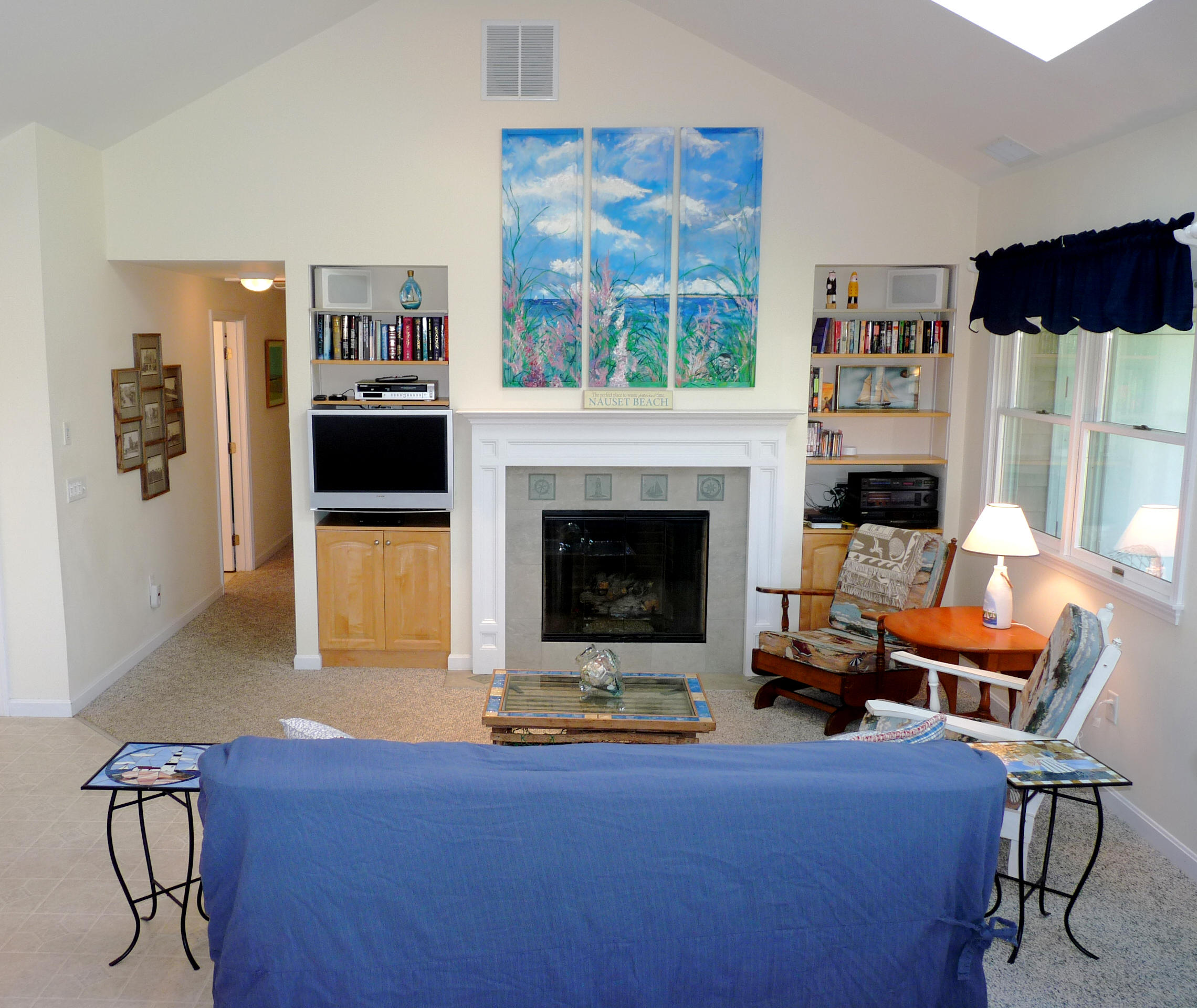 170 Beach Road, Unit 10 Orleans, MA 02653 - Photo 1 of 23 a living room with furniture a flat screen tv and a fireplace