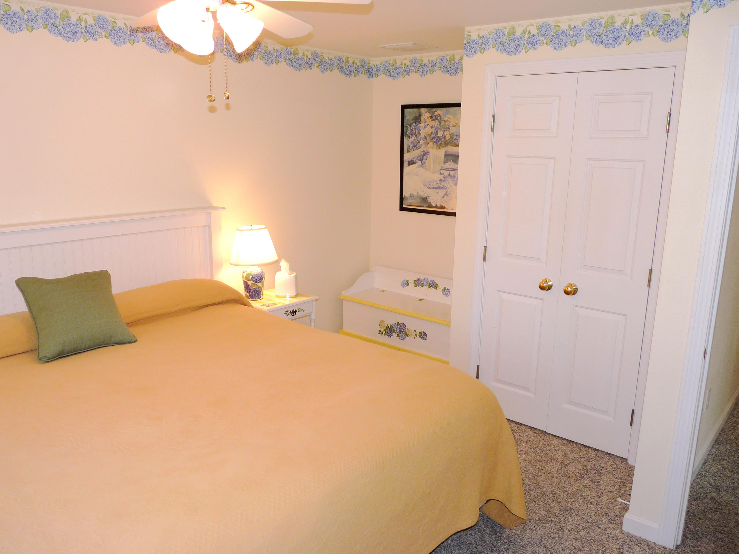 170 Beach Road, Unit 10 Orleans, MA 02653 - Photo 11 of 23 a bedroom with a bed and a mirror