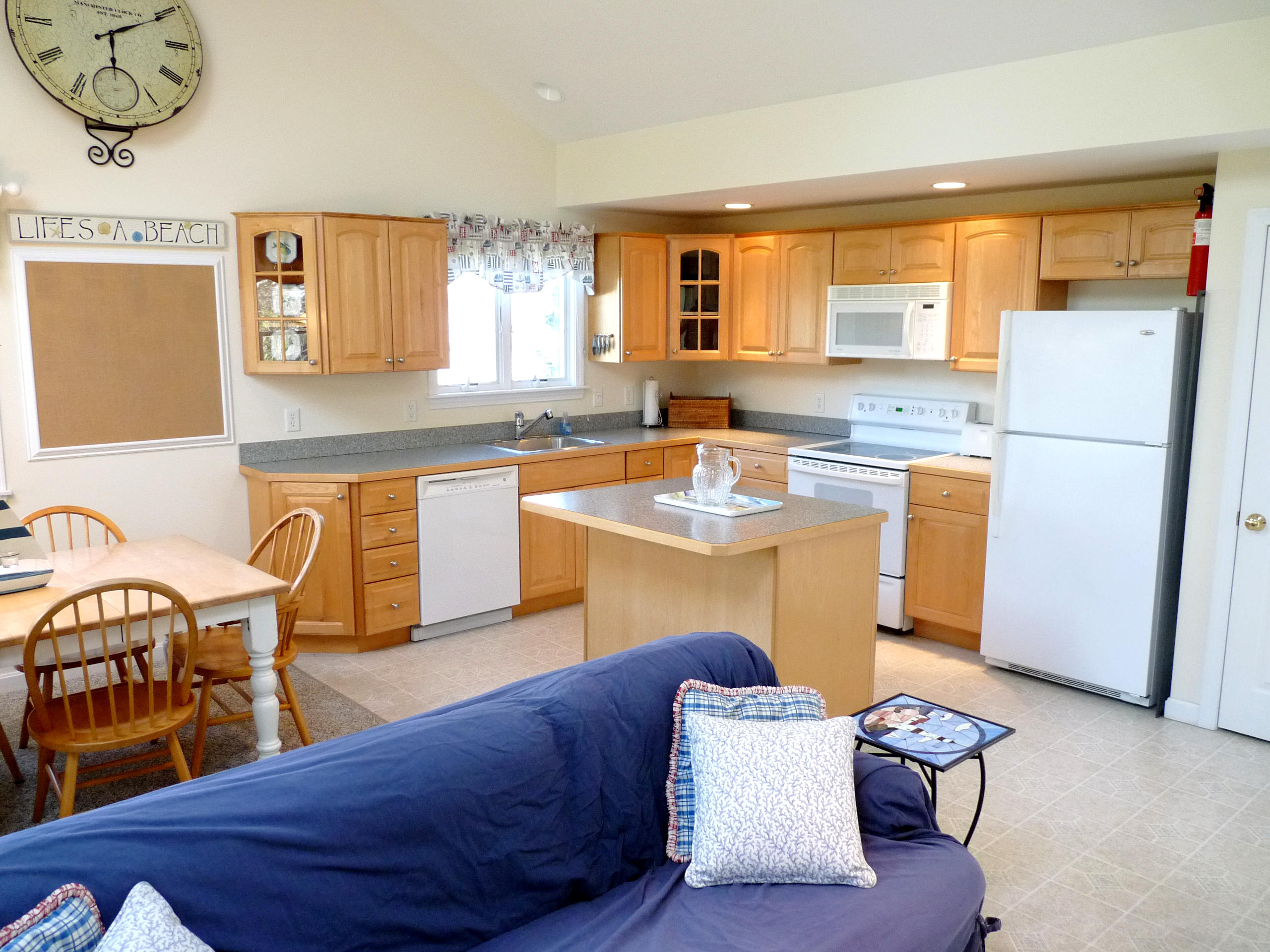 170 Beach Road, Unit 10 Orleans, MA 02653 - Photo 9 of 23 a living room with stainless steel appliances granite countertop furniture a couch and a window