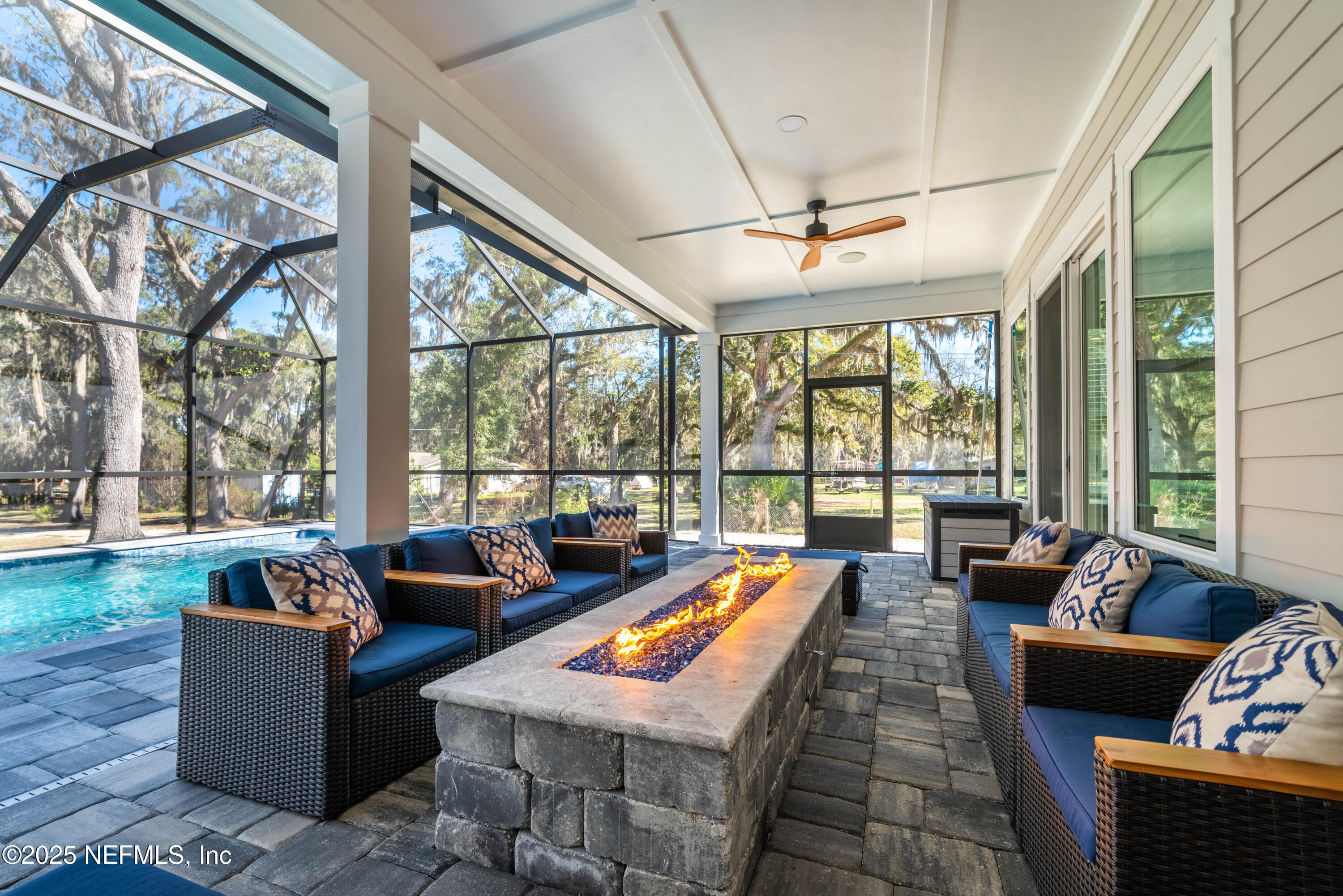 95494 Arbor Lane Fernandina Beach, FL 32034 - Photo 35 of 45 a living room with patio furniture and a floor to ceiling window