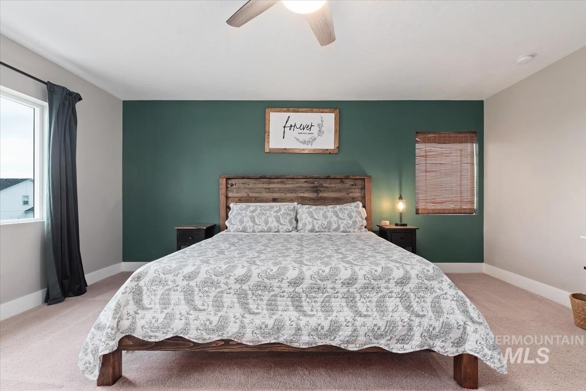 815 Knowledge Street Middleton, ID 83644 - Photo 25 of 49 Spacious room featuring a prominent accent wall and light-colored carpeting