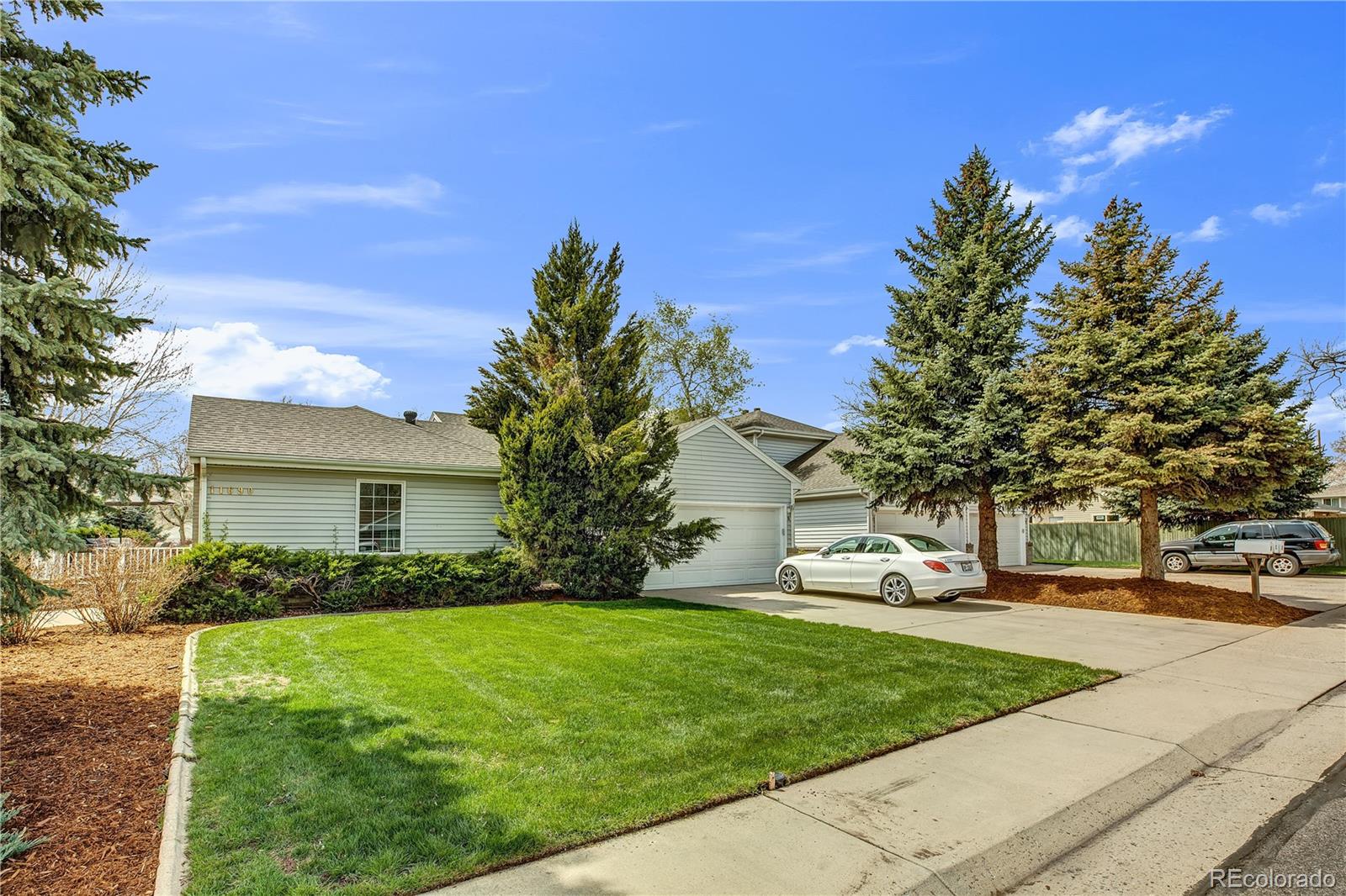 11690 West 46th Avenue Wheat Ridge, CO 80033 - Photo 3 of 33 a front view of a house with garden