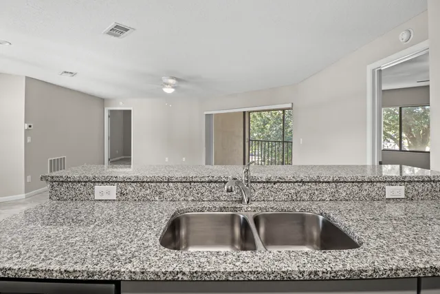 a kitchen with kitchen island granite countertop a sink and counter space