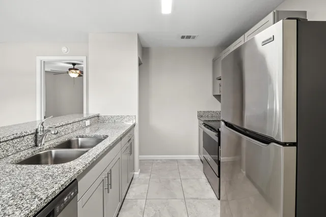 a kitchen with a sink and refrigerator