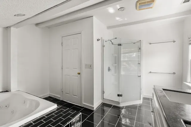 a bathroom with a bathtub and shower