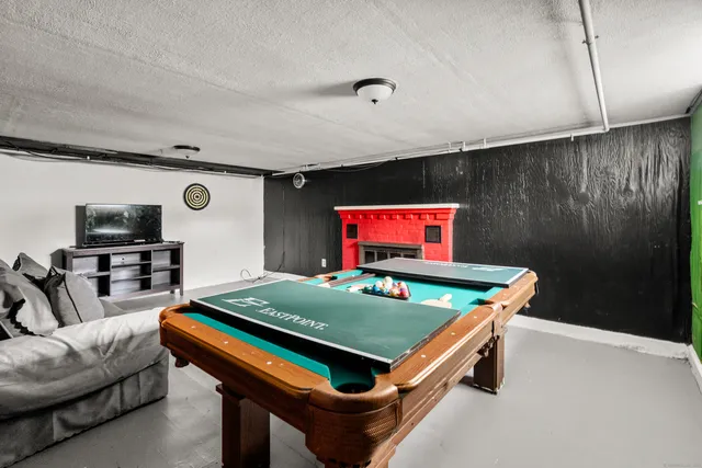a bedroom with furniture and a air conditioner vent