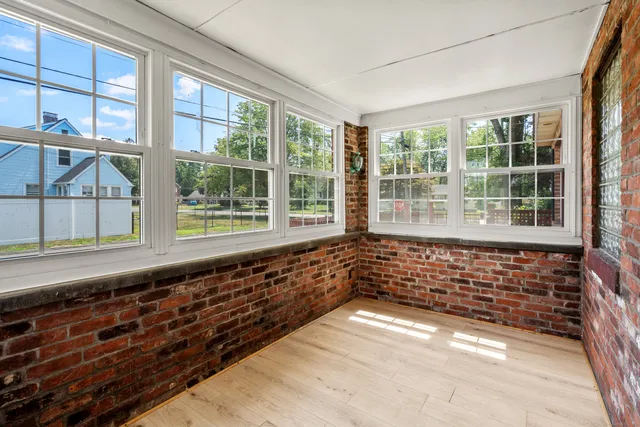 a view of a big yard with plants and large trees