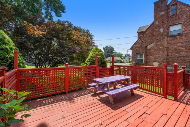 a view of a roof deck with wooden floor and fence
