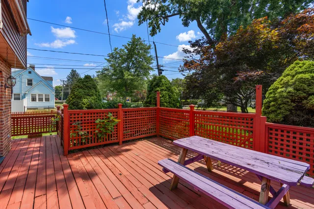 a backyard of a house with barbeque oven and outdoor seating