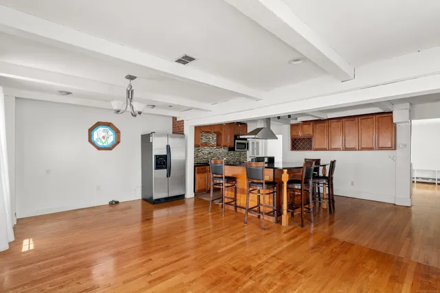 a view of a dining area with furniture and wooden floor