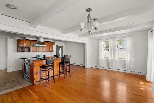 a view of a livingroom with furniture wooden floor and a window