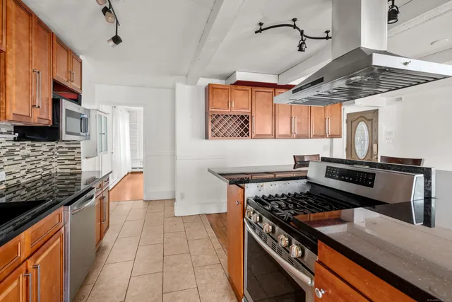 a kitchen with stainless steel appliances granite countertop a stove and a sink