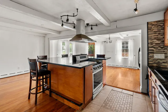 a kitchen with stainless steel appliances granite countertop a stove and a refrigerator