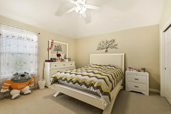 a bedroom with bed and window