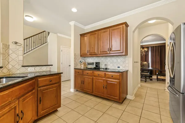 a kitchen with stainless steel appliances granite countertop a stove sink and cabinets