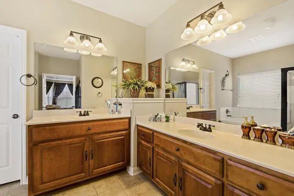 a spacious bathroom with a double vanity sink mirror and