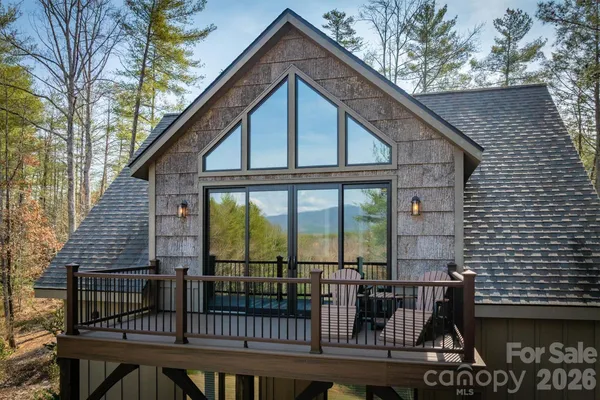 a view of a house with large windows and a table