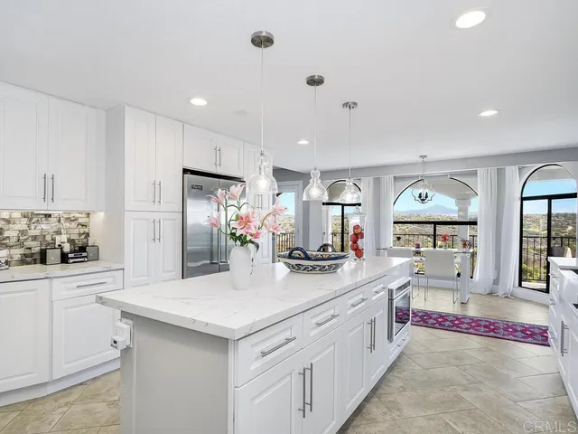 a living room with furniture large window and a fireplace