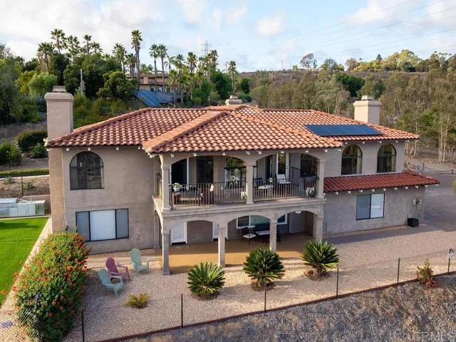 an aerial view of a house with garden space and sitting area