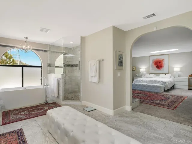 a living room with furniture dining table a window and a flat screen tv