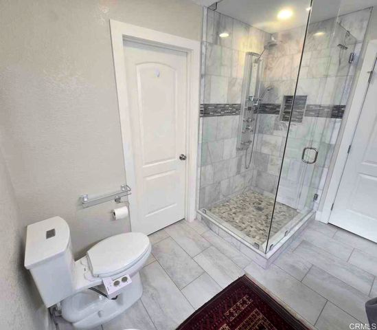 a bathroom with a double vanity sink and mirror with window